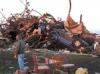 A man stands near a pickup that belonged to farmer Curt Zehr aer a tornado blew through Zehr's farm on Sunday, Nov. 17. 2013.